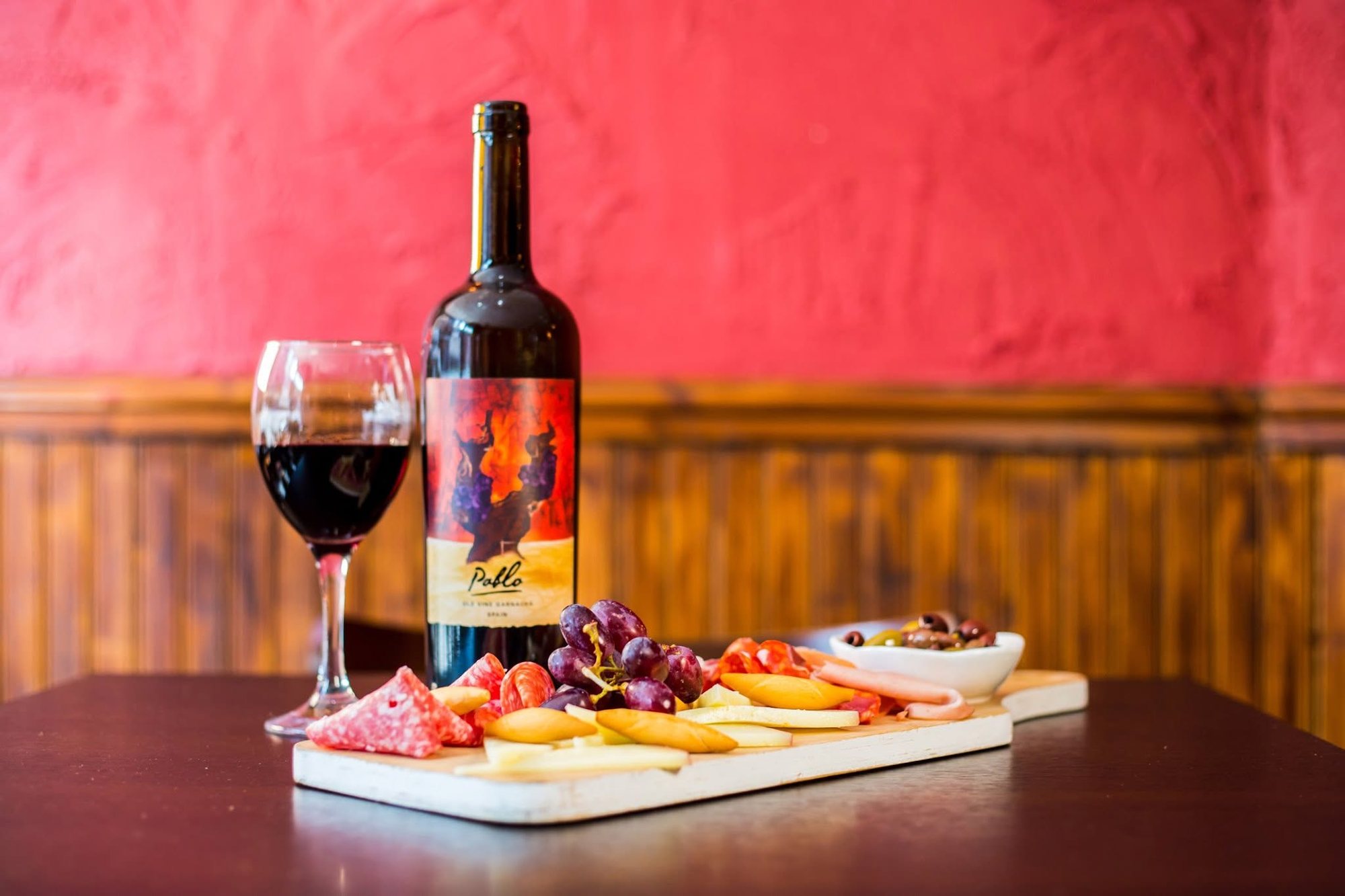 Wine, tapas and a red wall inside Tapas Factory