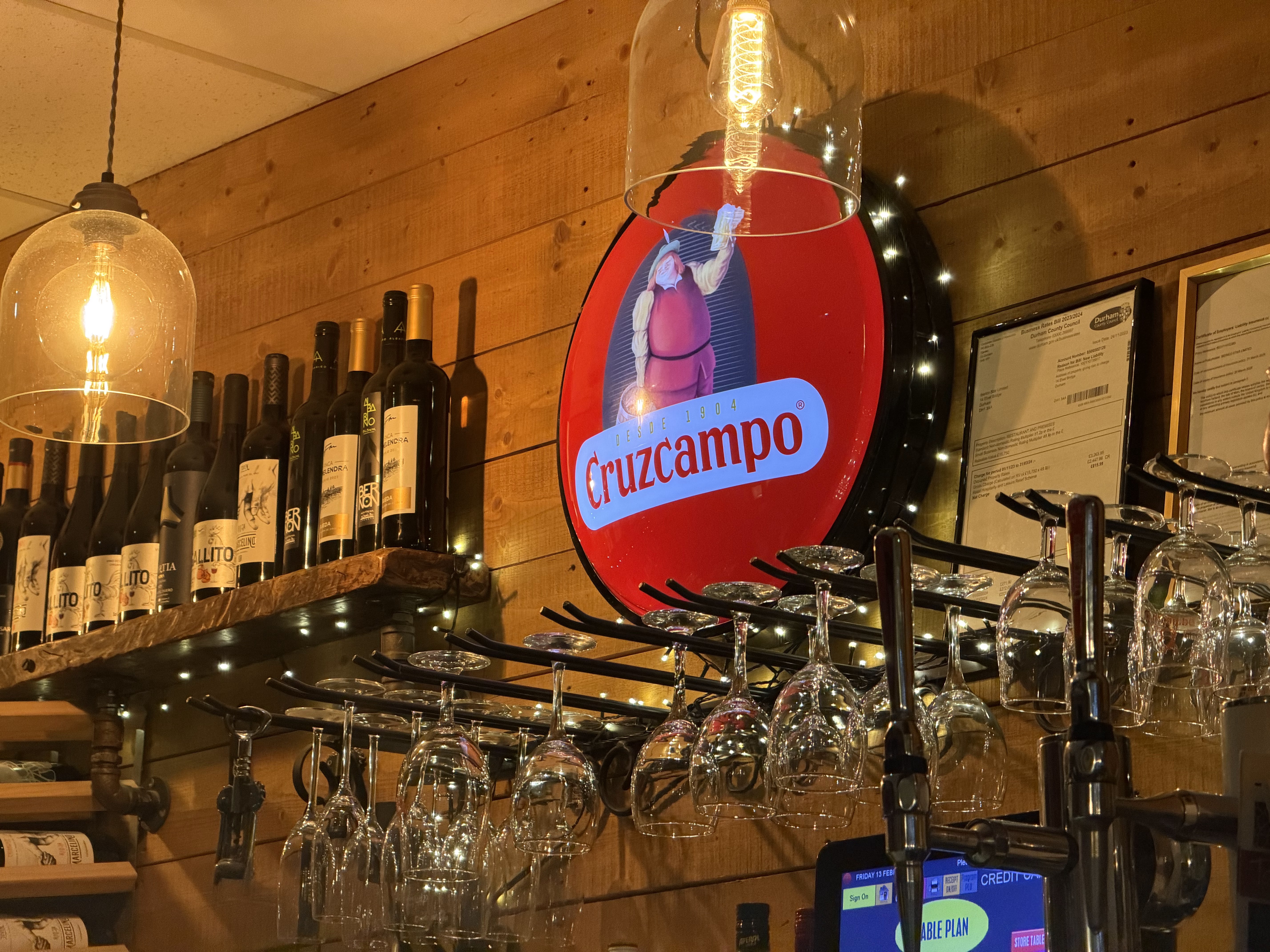 Tapas Factory bar with a Cruzcampo sign and wine glasses